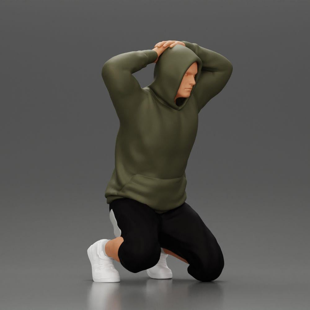 Diorama Modellismo foto prodotto 0: Uomo inginocchiato con felpa con cappuccio, mani dietro la testa - Miniatura Diorama (Rif. Nr. A70)