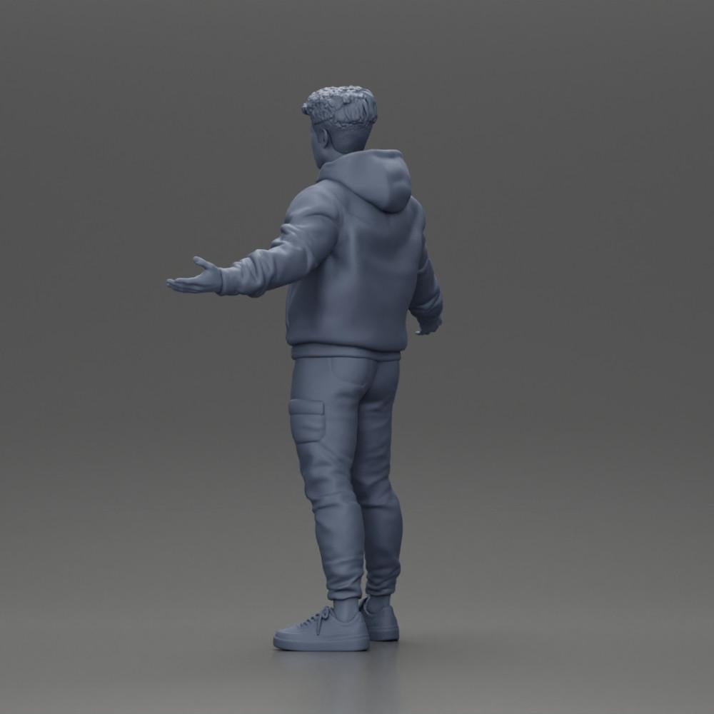 Diorama modelářství produktová fotografie 10: Miniaturní figura asijského muže v mikině s kapucí, ruce vztyčené do stran (Ref č. A60)